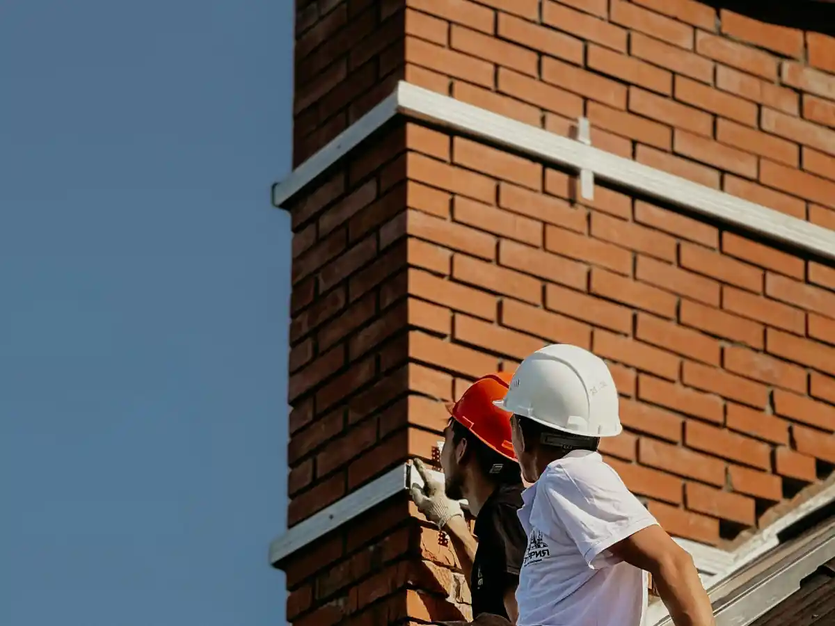 Mason working on a chimney crown