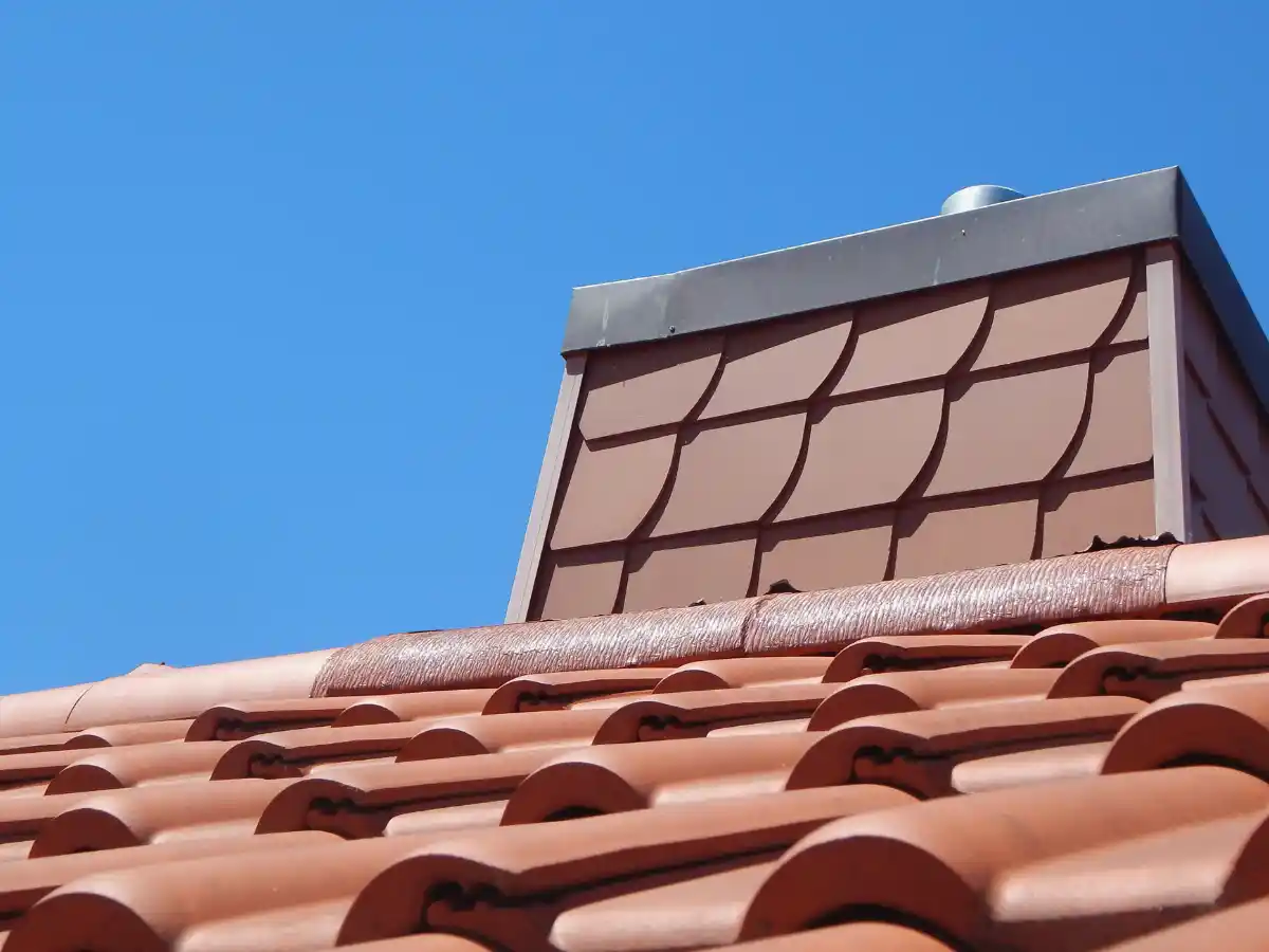 Brick chimney above a tile roof