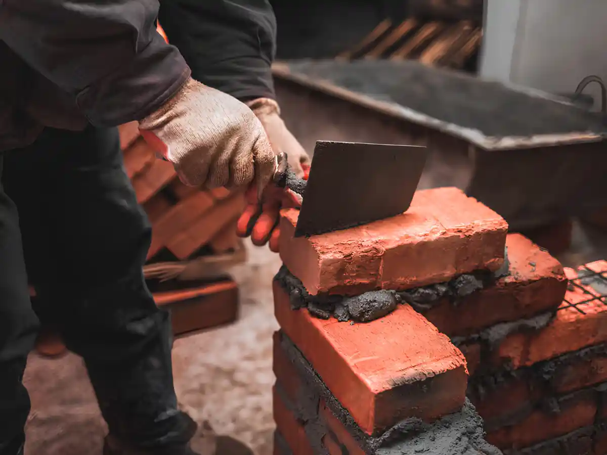Mason rebuilding chimney brickwork