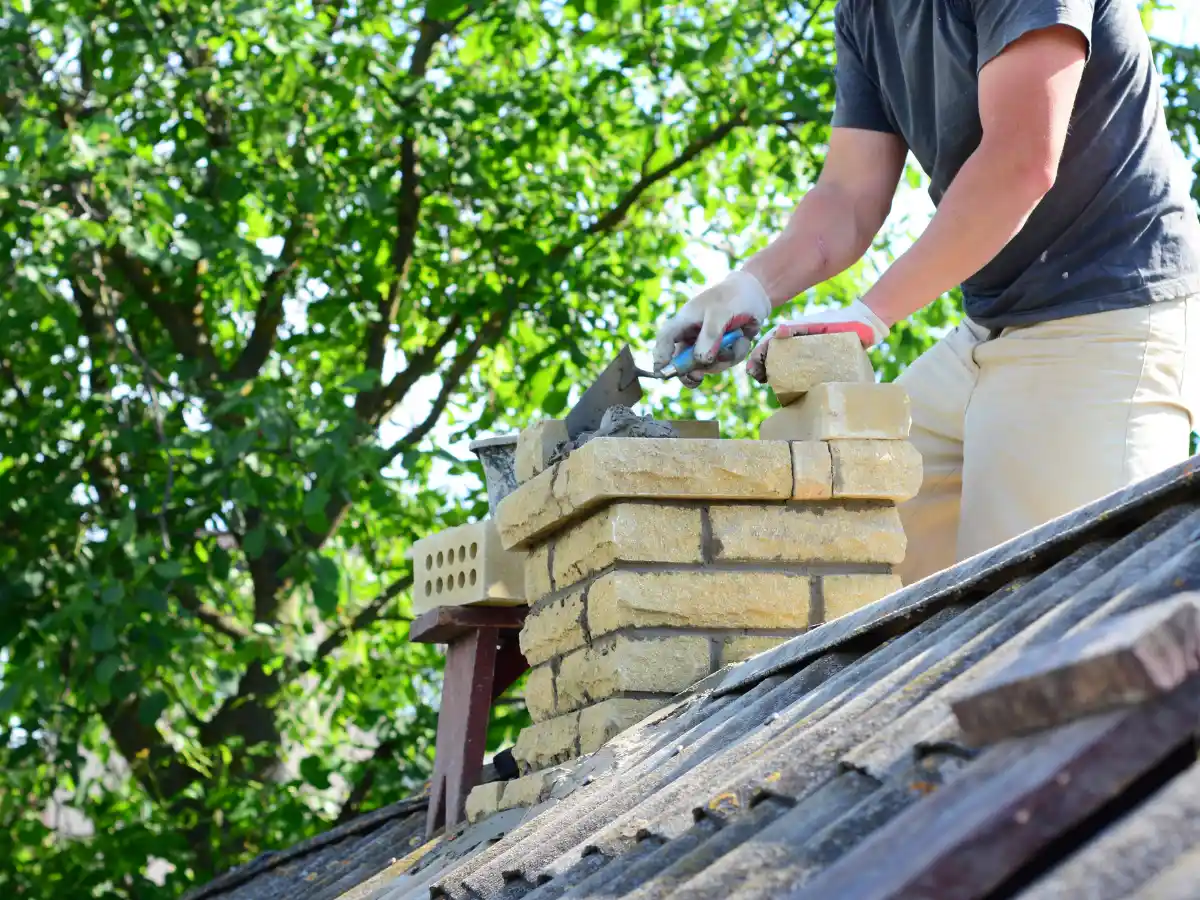 Mason rebuilding chimney brickwork