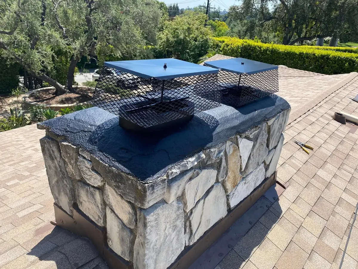 Stone chimney with a metal cap